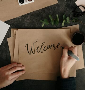 person writing on brown paper