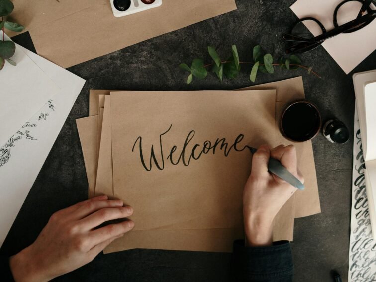 person writing on brown paper