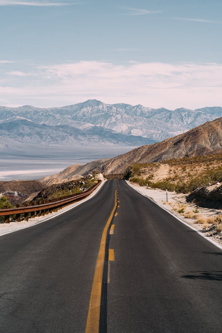 empty gray road under white clouds